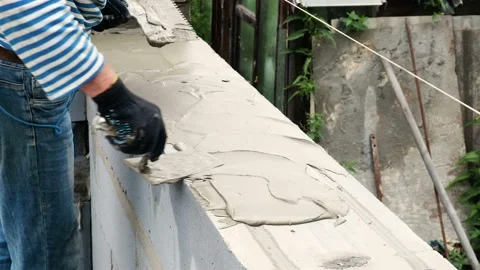 Bricklayer putting down another row of bricks in site Stock Footage 113397918