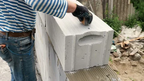 Bricklayer putting down another row of bricks in site Stock Footage 113401748