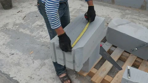 Bricklayer putting down another row of bricks in site Stock Footage 113406734