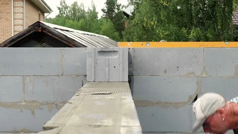 Bricklayer putting down another row of bricks in site Stock Footage 113406870