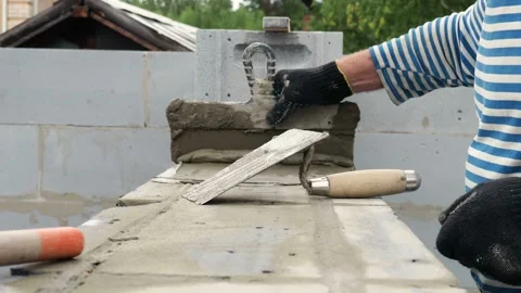 Bricklayer putting down another row of bricks in site Stock Footage 113406977