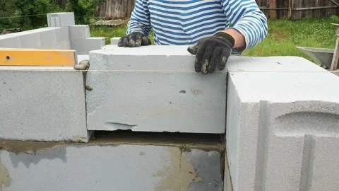 Bricklayer putting down another row of bricks in site Stock Footage 113410970