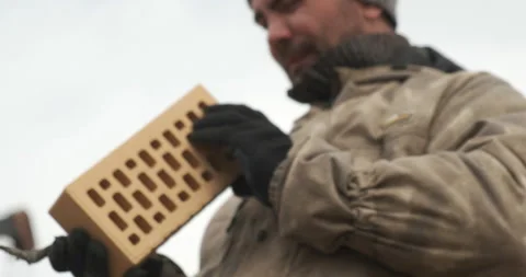 Bricklayer Takes on Hand Brick, Checks Integrity and Laying of Brick Laying Stock Footage 144164446