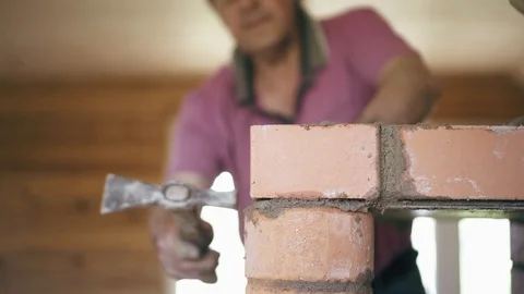 Bricklayer is using professional equipment to build a fireplace. Repair process Stock Footage 90094759