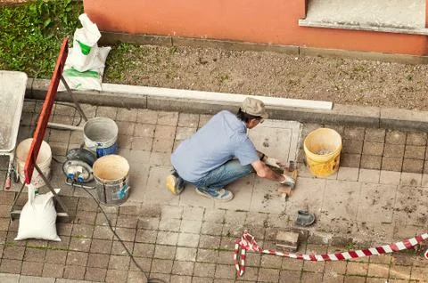 Bricklayer at work laying stone blocks. Stock Photos