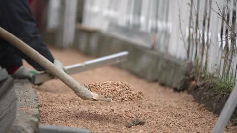 The bricklayer workers levels the floor using a spirit level and sand before  Video stock 319884227