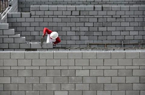 Bricklayer working on brick wall Stock Photos