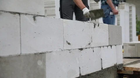Bricklayers are building a wall from aerated concrete blocks. Stock-Footage 103126883