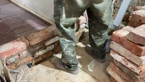 Bricklaying with Clay for Wall Construction Stock Footage 316539395