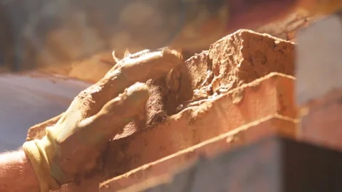 Bricklaying. Hands That Put A Brick On wall wooden stove Stock Footage 123799697