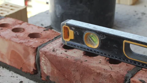Bricklaying with level tool on construction site Stock Footage 314644838