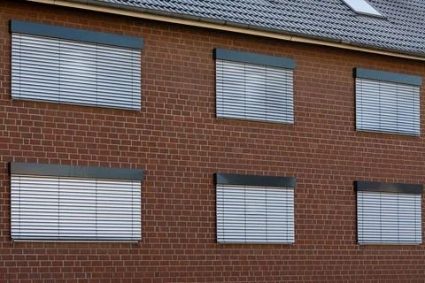 Bricks and blinds create a simple architectural design in a home Stock Photos