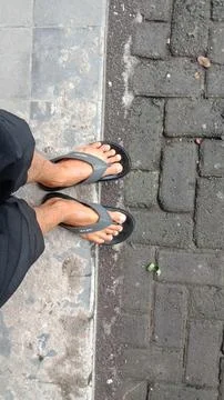 Bricks and human feet Stock Photos