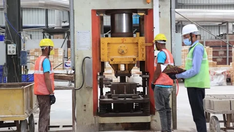 Bricks are being made into High quality press machine, operator wearing PPE kit Stock-Footage 251449219