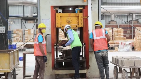 Bricks are being made into High quality press machine, operator wearing PPE kit Stock-Footage 251449361