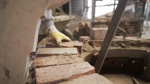 Bricks are laid using a template to form a bell shape Stock Footage 220904067