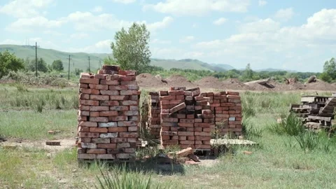 The bricks are stacked on pallets against the backdrop of mountains. Khakassia. Stock Footage 258027872