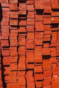 Bricks are stacked tightly in a construction area during the day. The uniform 스톡 사진