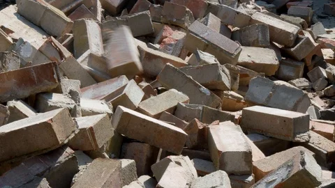 Bricks are Thown onto a Pile of Construction Rubble Stock Footage 107769278