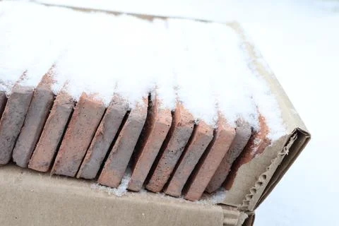 Bricks beautifully covered in snow create a stunning winter landscape and Stock Photos