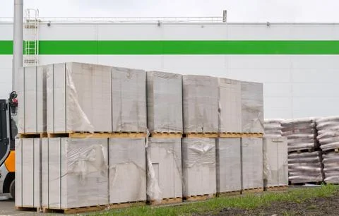 Bricks, blocks from a sibit and other construction materials on wooden pallets Stock Photos
