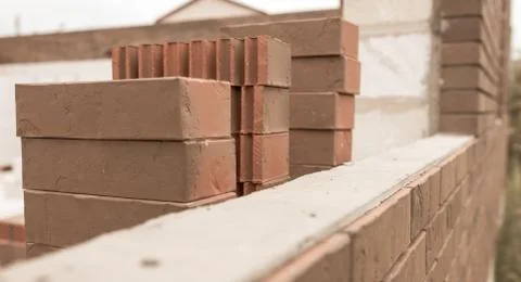 Bricks on a house under construction. Stock Photos