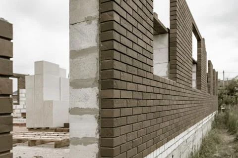 Bricks on a house under construction. Stock Photos