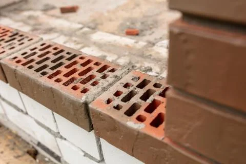 Bricks on a house under construction. Stock Photos