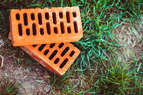 Bricks lie on the grass Stock Photos