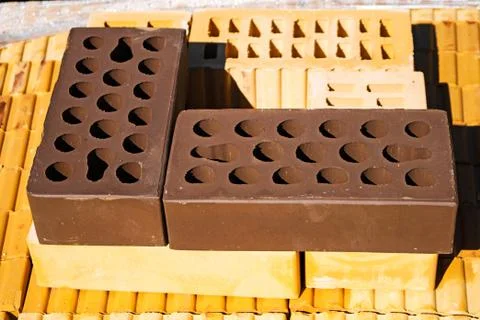 Bricks pallet on a construction site, brown brick. Stock Photos
