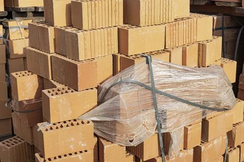 Bricks in pallets on a construction site. Construction Materials. 스톡 사진