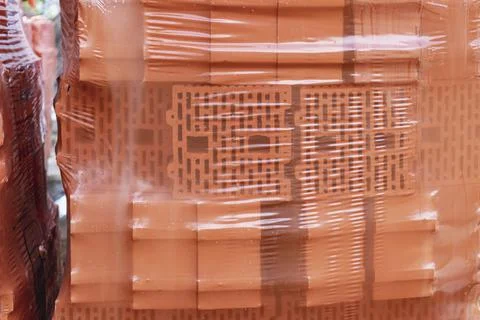 Bricks in pallets on a construction site. Construction Materials. Stock Photos