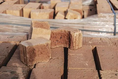 Bricks in pallets on a construction site. Construction Materials. Stock Photos