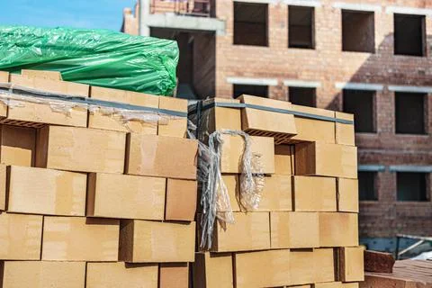 Bricks in pallets on a construction site. Construction Materials. Stock Photos