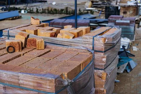 Bricks in pallets on a construction site. Construction Materials. Stock Photos