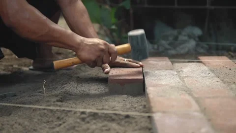 Bricks Pounded into the ground. Bricks Pounded into the ground Stock Footage 160036346