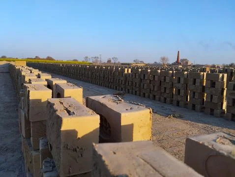 Bricks Un baked bricks Raw bricks Kiln Brick kiln Blue sky Chimney Stock Photos