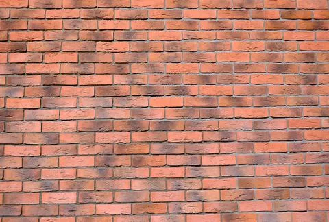 Brickwork in the construction of the house red-brown brick. 库存照片