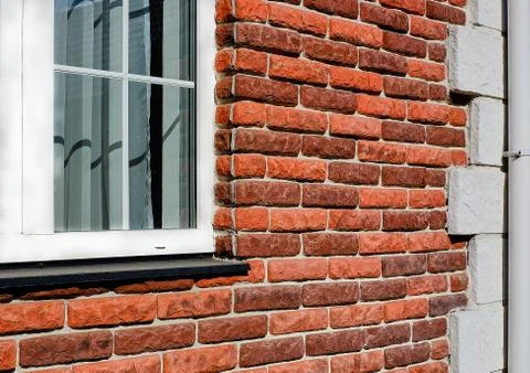 Brickwork in the construction of the house red-brown brick. Stock Photos