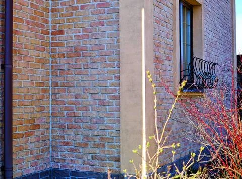 Brickwork in the construction of the house red-brown brick. Stock Photos