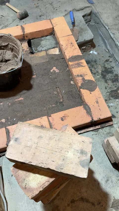 Brickwork of the heating furnace base Bucket with masonry mortar Stove cons.. Stockbeeldmateriaal 321618151