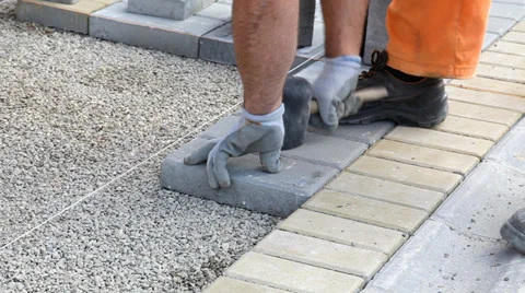 Brickwork, mason laying concrete bricks to gravel Stock Footage 36723503