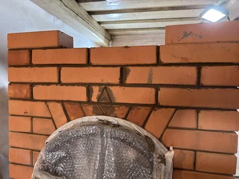 Brickwork of a newly built heating stove. Decorative elements. Stock Photos