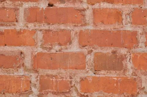 Brickwork of old red bricks with glossy white joints. Stock Photos