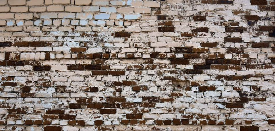 The brickwork of the old wall, uneven bricks and protruding mortar Stock Photos