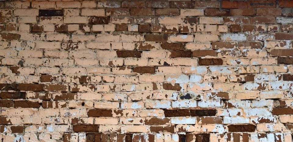 The brickwork of the old wall, uneven bricks and protruding mortar Stock Photos