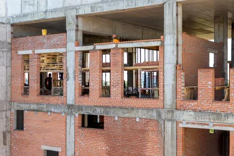 Brickwork of outer walls of frame monolithic structure, formation of window Stock Photos