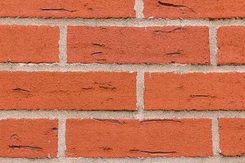 Brickwork rectangular red stones cracks with cement gray lines parallel row n Stock Photos