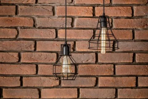 Brickwork, red brick. A piece of the wall. Black metal lamp. Background texture. Stock Photos