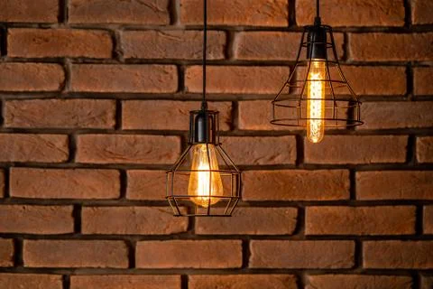Brickwork, red brick. A piece of the wall. Black metal lamp. Background texture. Stock Photos